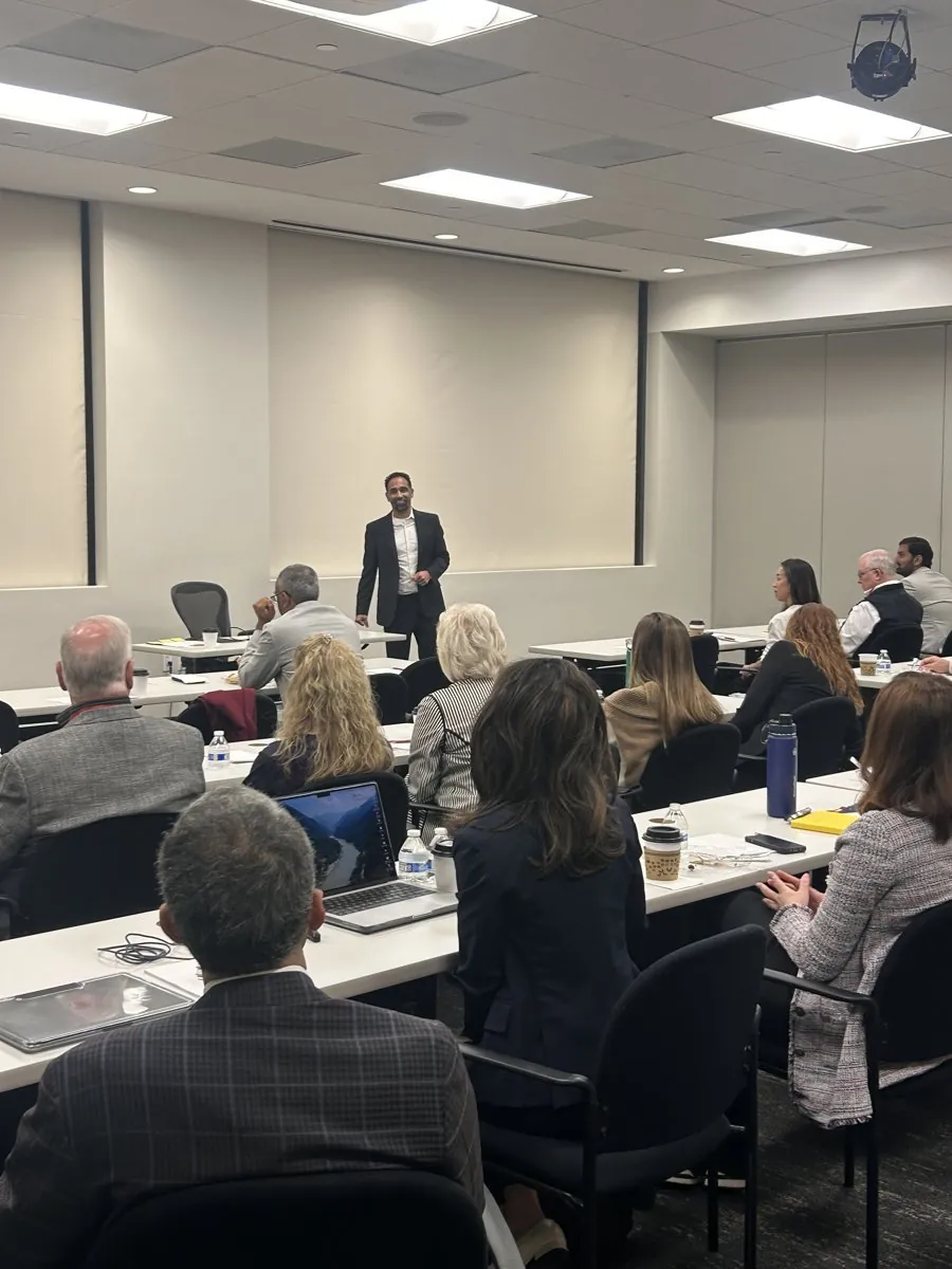 Suken leading a session for a room of executives